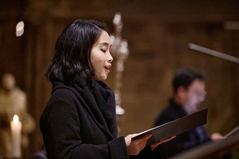 Cellist and soloist performing during a festive concert at St. Anna Church