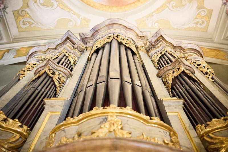 Trumpet performance with architectural detail of baroque church in the background.